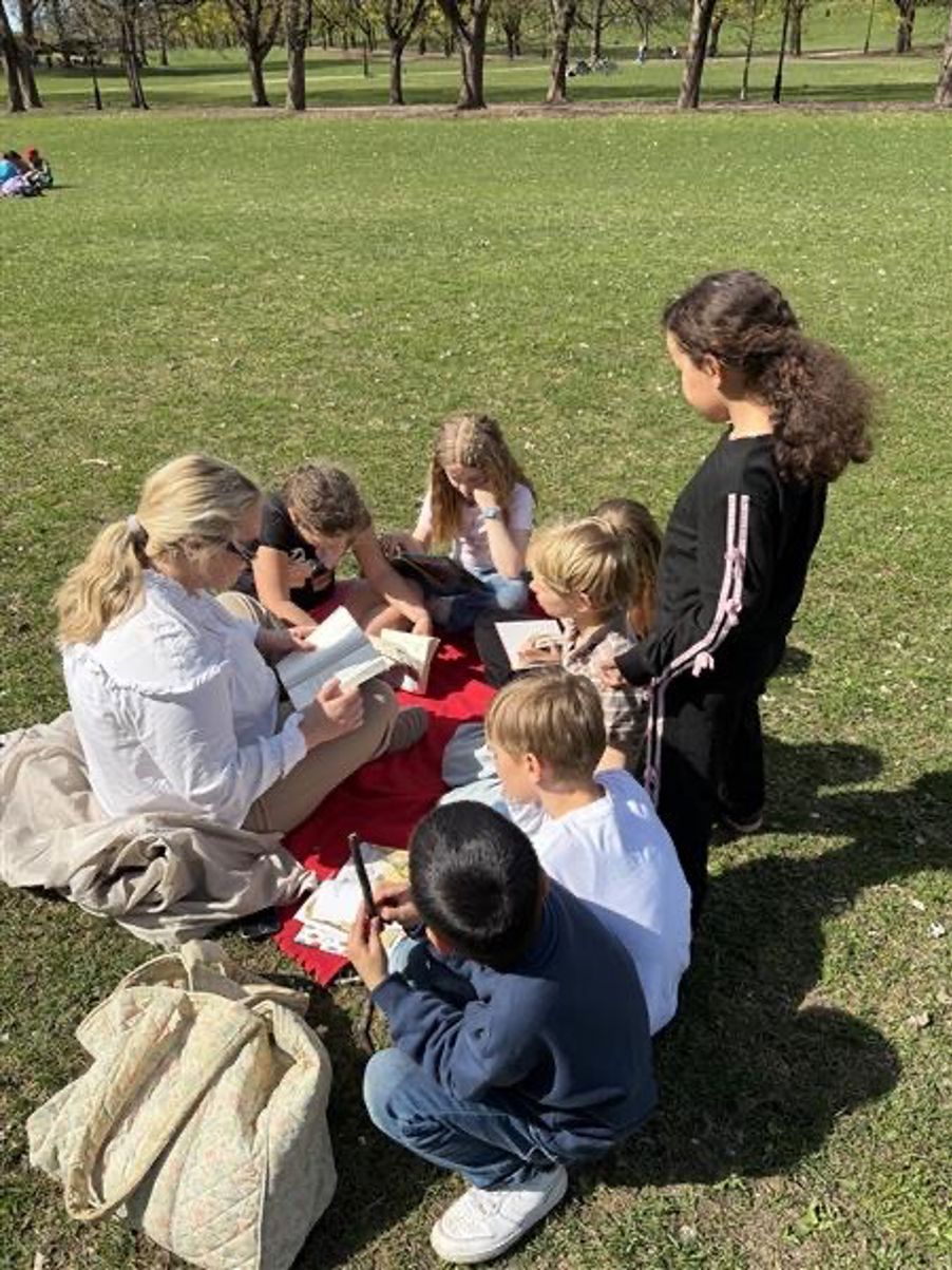 en gruppe mennesker som sitter på gresset